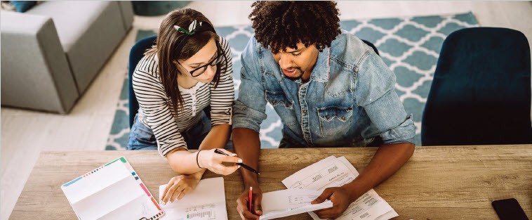 Man and woman reviewing financial documents together
